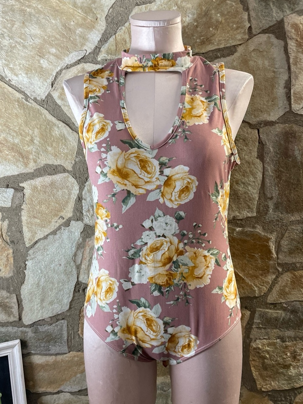 TMG New York floral V neck bodysuit with snap closure.